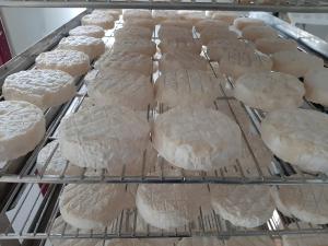 a bunch of uncooked breads on a cooling rack at Gîte à la ferme- Chalet à la nuitée in Mazan-lʼAbbaye