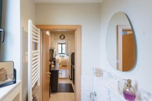 a bathroom with a mirror and a hallway at Ferienwohnung Baltic in Barth