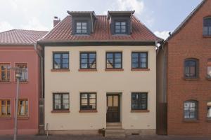 a white house with black windows at Ferienwohnung Baltic in Barth