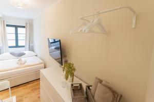 a bedroom with a bed and a desk with a mirror at Ferienwohnung Baltic in Barth