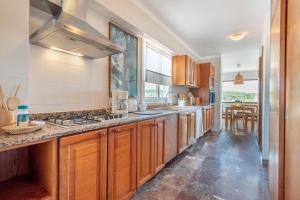 a kitchen with wooden cabinets and a counter top at Bennassar 3 in Felanitx