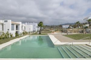 a swimming pool in the middle of a house at Moderno Apartamento Atlanterra in Zahara de los Atunes