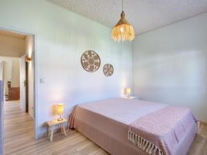 a bedroom with a large bed and a chandelier at Villa 32 - Villa With Garden in Esposende