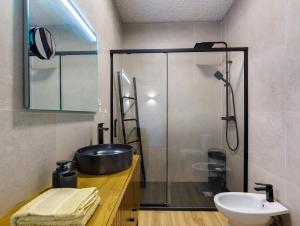 a bathroom with a sink and a glass shower at Villa 32 - Villa With Garden in Esposende +16 photos