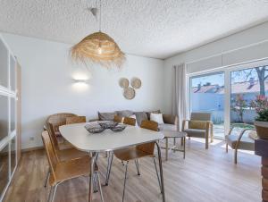 a living room with a table and chairs and a couch at Villa 32 - Villa With Garden in Esposende