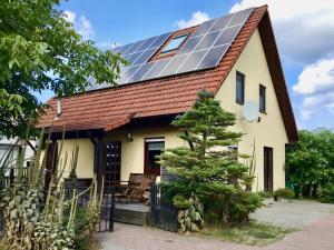 a house with solar panels on the roof at Haus Peeneblick in Freest