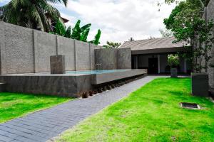 a house with a swimming pool in a yard at Villa R in Negombo