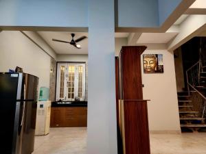 a kitchen with a refrigerator and a stair case at Twilight Stays ll 2 Bed Villa ll Swimming Pool ll AC ll BBQ in Lonavala