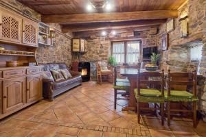 a living room with a couch and a table at Casa Rural Cornatel in Villavieja
