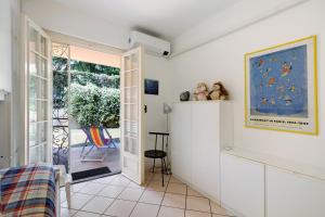 a room with a door leading to a patio at Casa Ghibli in Loano
