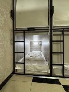 a room with two bunk beds in a room at Palm Hostel in Tashkent