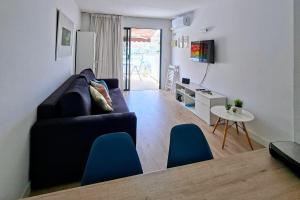 a living room with a couch and a table at Canaima 223 - Puerto Rico in Puerto Rico de Gran Canaria
