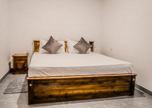 a bedroom with a bed with white sheets and pillows at Villa R in Negombo +23 photos