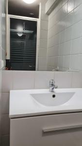 a bathroom with a white sink and a mirror at Haras de la fontaine Datcha in Poligny +12 photos