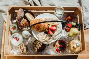 a wooden tray with a tray of bread and pastries at Apartment Andreas - Gallhof in Vollan +31 photos