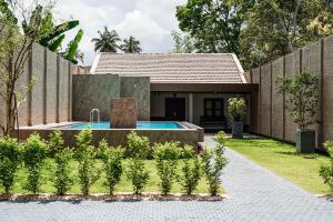 a house with a swimming pool in a yard at Villa R in Negombo