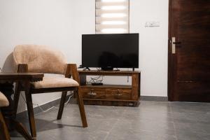 a living room with a television and a chair at Villa R in Negombo
