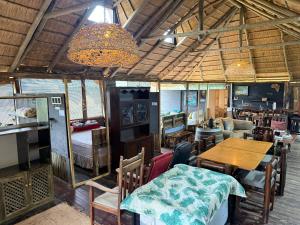 a living room with a table and a dining room at Serendipity Guest Farm Byrne in Byrne