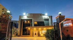 a building with two lights on top of it at Hotel Ramleela in Rāmeswaram