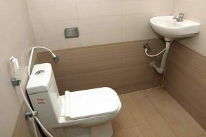a bathroom with a toilet and a sink at Hotel Ramleela in Rāmeswaram +12 photos