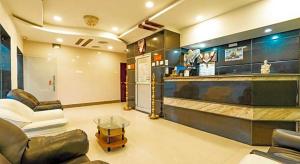 a living room with a couch and a table at Hotel Ramleela in Rāmeswaram