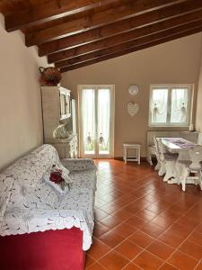a bedroom with a bed and a table and windows at Maltina country house in Savona