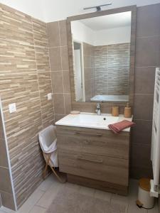 a bathroom with a sink and a mirror at BLEU AZUR in Fréjus +28 photos