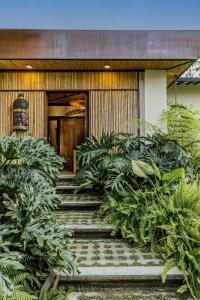 a building with a bunch of plants in front of it at Tukki Ecolodge Hotel in Filandia