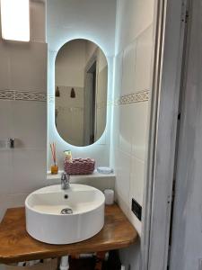 a bathroom with a white sink and a mirror at Maltina country house in Savona