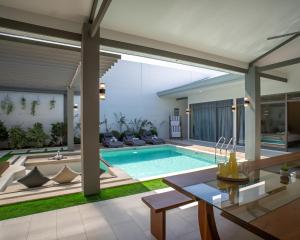 a swimming pool in a house with a living room at Villa Kalachuchi Bohol in Panglao Island