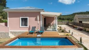 a villa with a swimming pool and a house at Sonny 2 Bedroom House in Koukounariá