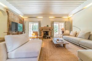 a living room with white furniture and a fireplace at Villa Alegria in Azeitao