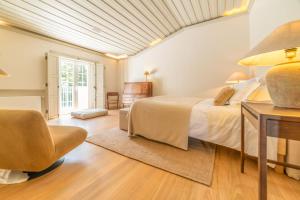 a bedroom with a bed and a desk and a chair at Villa Alegria in Azeitao +64 photos