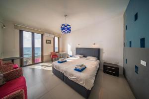 a bedroom with a large bed with a view of the ocean at Villa Pantheon with Private Pool & Jacuzzi in Pomos +91 photos