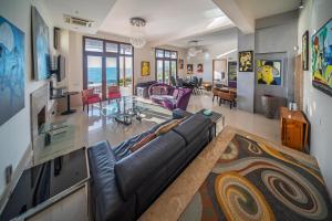 a living room with a couch and a table at Villa Pantheon with Private Pool & Jacuzzi in Pomos