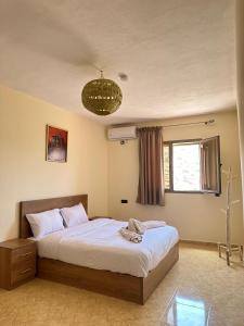 a bedroom with a large bed with a chandelier at Green Valley Lodge - Atlas Mountains Nature in Taroudant +31 photos