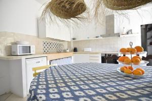 a kitchen with a table with oranges on it at S'abeurada con piscina en Soller in Sóller