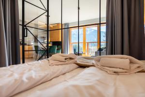 a large bed in a room with a large window at Mountain Mood by Apart Concept Podhale in Kościelisko