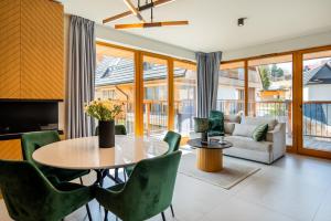 a living room with a table and chairs at Mountain Mood by Apart Concept Podhale in Kościelisko
