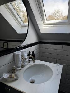 a bathroom with a white sink and a mirror at The Bellachroy in Dervaig +35 photos
