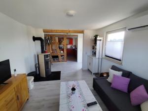 a living room with a couch and a table at Ferienwohnung am See in Ostrach