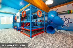 a play room with a slide in it at Domki Kropla Bałtyku in Darłowo