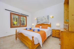 a bedroom with a large bed and a dresser at Villa El Mal Pas / Can Seguinet in Alcudia +22 photos