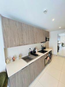 a kitchen with a sink and a counter top at Nomah Homes The Bantree in Accra