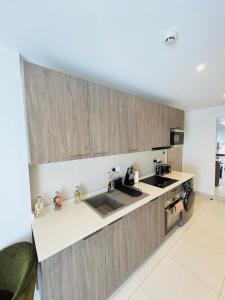 a kitchen with a sink and a counter top at Nomah Homes The Bantree in Accra +9 photos