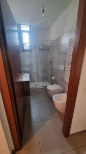 a bathroom with a toilet and a sink and a shower at Appartamento Trezzo sull'Adda in Trezzo sullʼAdda +10 photos