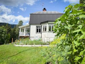 a white house with a large yard in front of it at House on the hill in Södra Persby