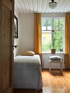 a bedroom with a bed and a window at House on the hill in Södra Persby