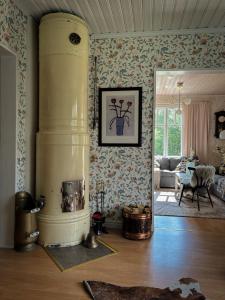 a living room with a fireplace in the middle of a room at House on the hill in Södra Persby