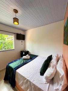 a bedroom with a large bed in a room at Pousada Oxente Uai! in Pirenópolis